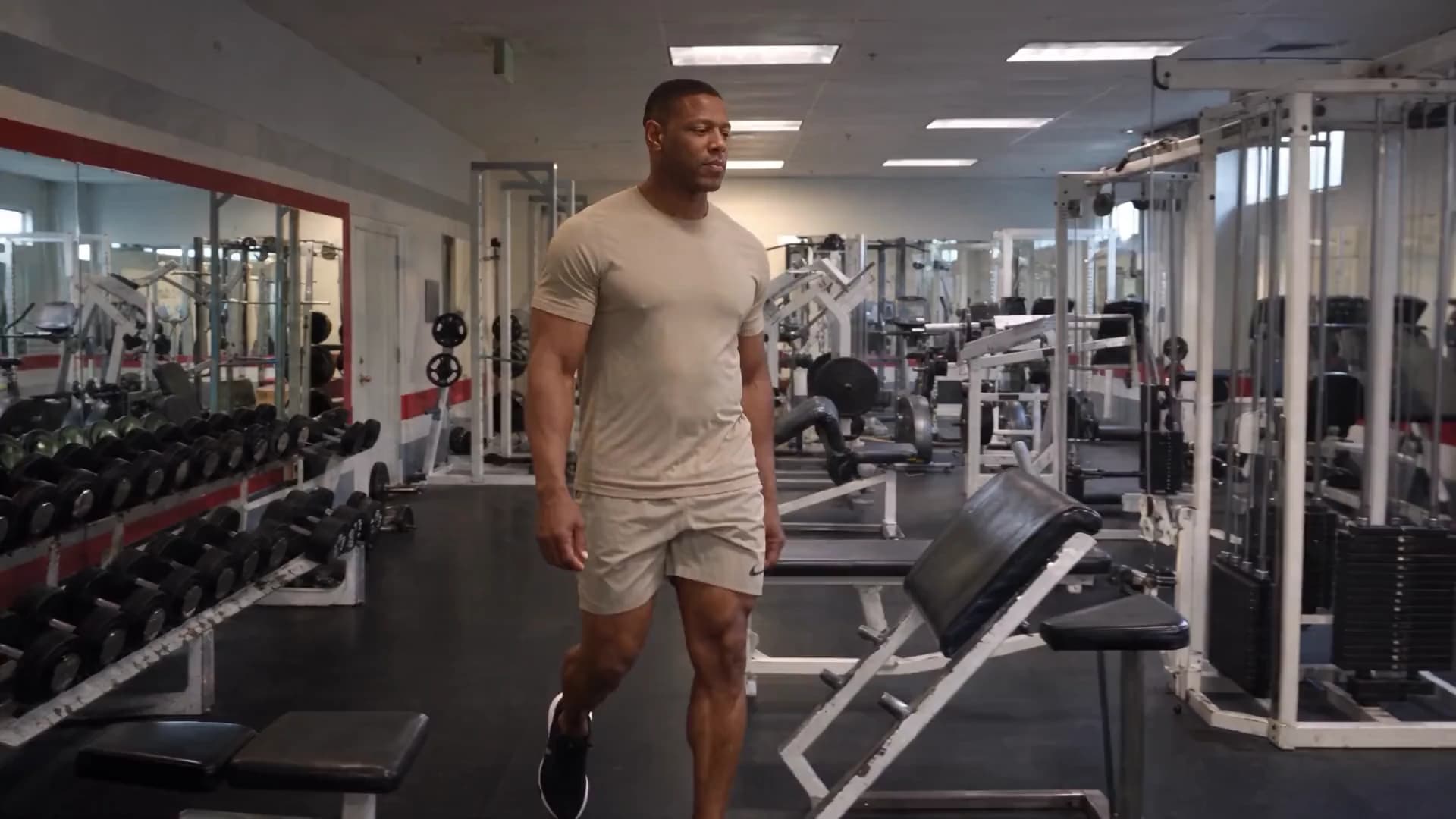 A man walking through a gym, on his way to a body composition scan for Omnis Body.